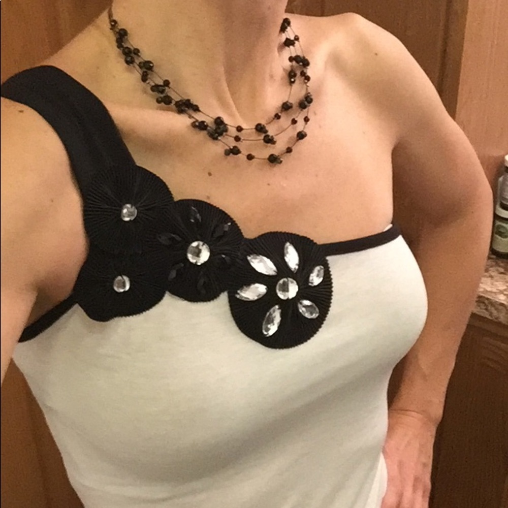 Taboo black and off-white one shoulder shirt.